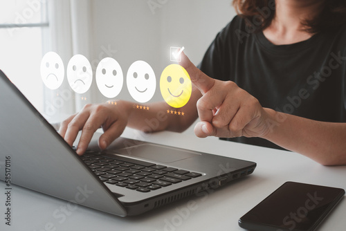 Obraz na płótnie Client's hand ticked the happy face smile face, Customer service evaluation and satisfaction survey concept