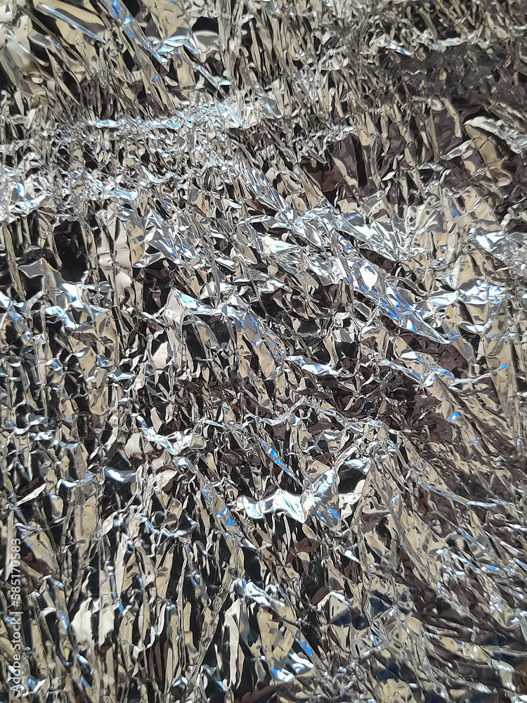 Crumpled aluminum foil. Wrinkled silver surface Crumpled aluminum foil. Wrinkled silver surface