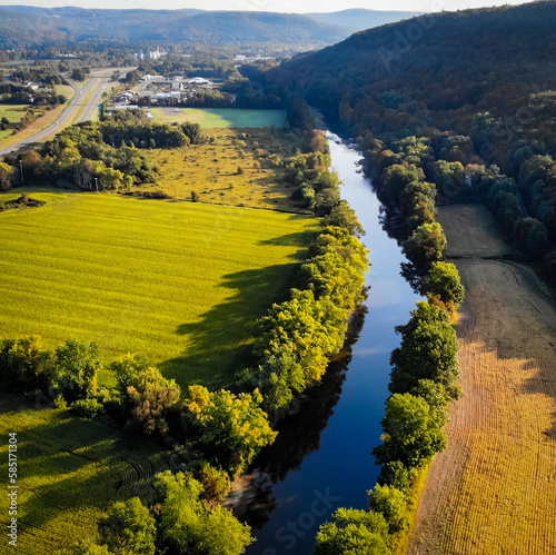 Valley view of farmland and river in very early fall, taken from an aerial view. 
