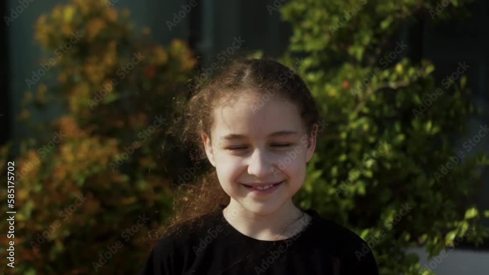 Happy child in park. Beautiful face. Happy Child in rays of the sun. Little girl face in park close-up portrait. Dream funny girl. Happy face of a child in rays of sun. Child smiles at camera. Face Happy child in park. Beautiful face. Happy Child in rays of the sun. Little girl face in park close-up portrait. Dream funny girl. Happy face of a child in rays of sun. Child smiles at camera. Face