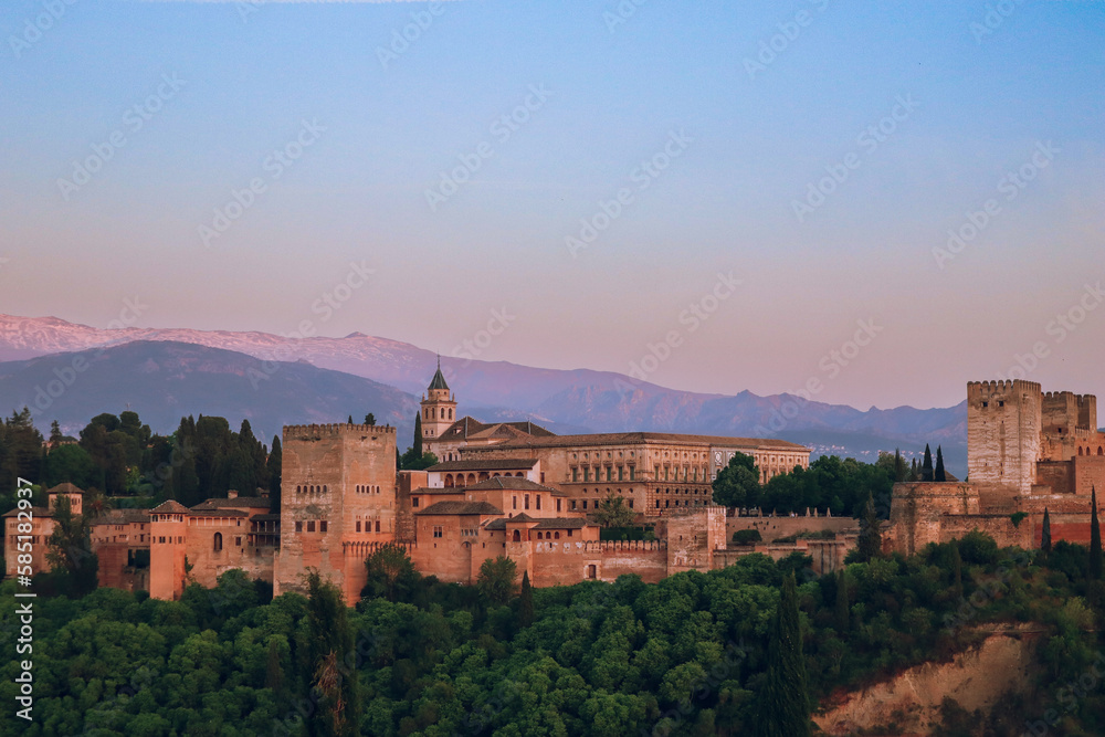 Sunset over Alhambra Palace and the Sierra Nevada mountains in Granada, Andalucia,  Spain