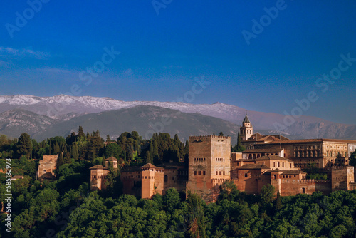 Sunset over Alhambra Palace and the Sierra Nevada mountains in Granada, Andalucia, Spain