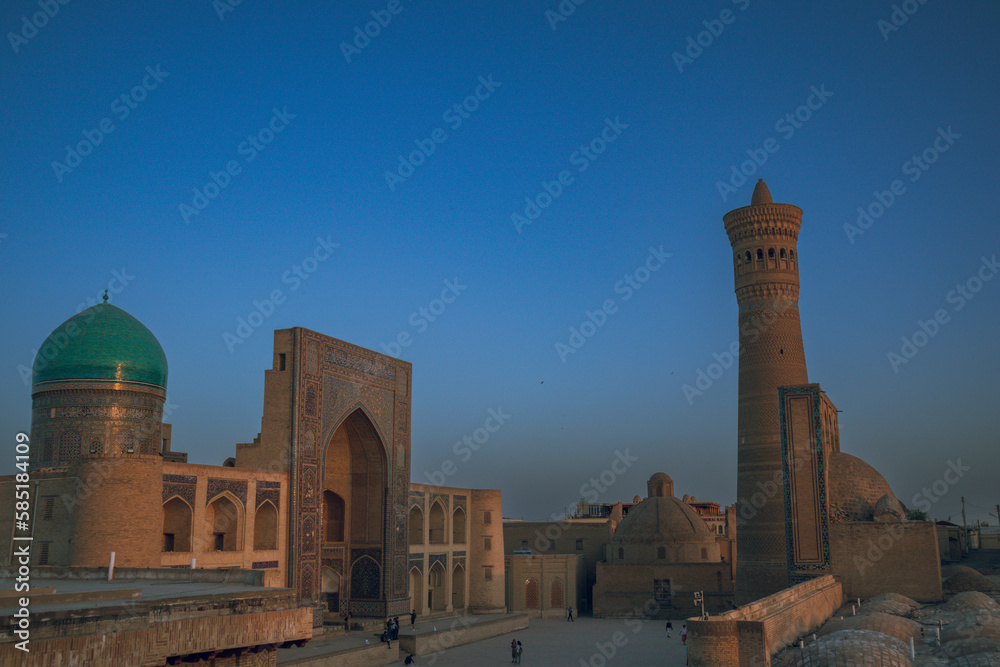 Sunet with panoramic view and Persian architecture in the ancient silk road city of Bukhara, Uzbekistan, Po-i-Kalan Islamic religious complex square, , Kalyan mosque and Bukhara Tower