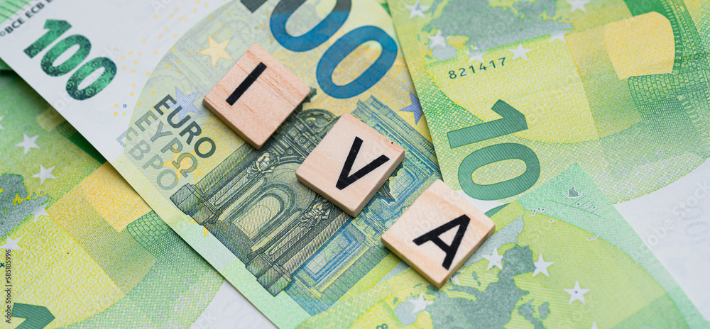 the inscription IVA or VAT in Italy next to euro banknotes. Concept showing value added tax the inscription IVA or VAT in Italy next to euro banknotes. Concept showing value added tax
