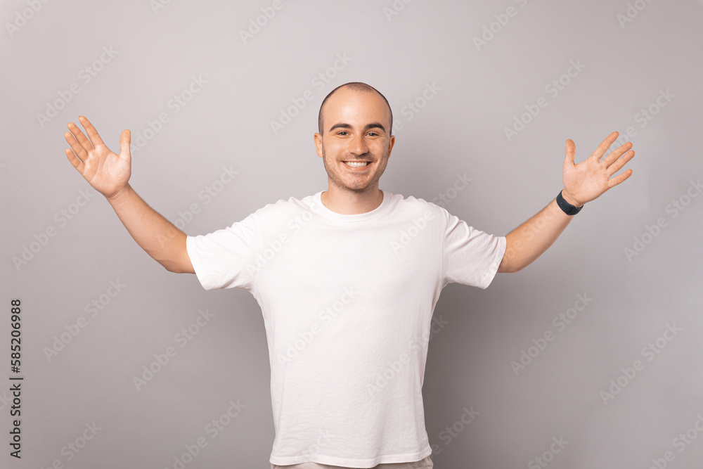 Handsome bald man is holding arms opened wide ready to hug and welcome you. Handsome bald man is holding arms opened wide ready to hug and welcome you.