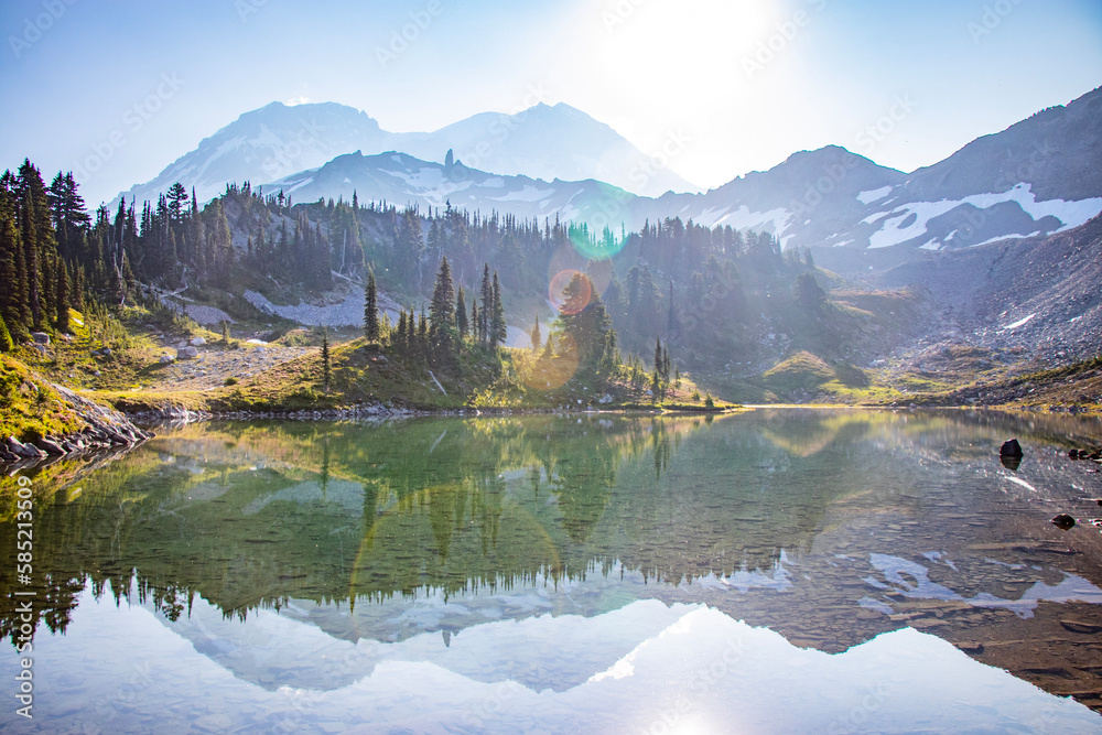 Obraz premium lake and mountains; Hiking the Wonderland Trail around Mt. Rainier; mountain landscape with clouds