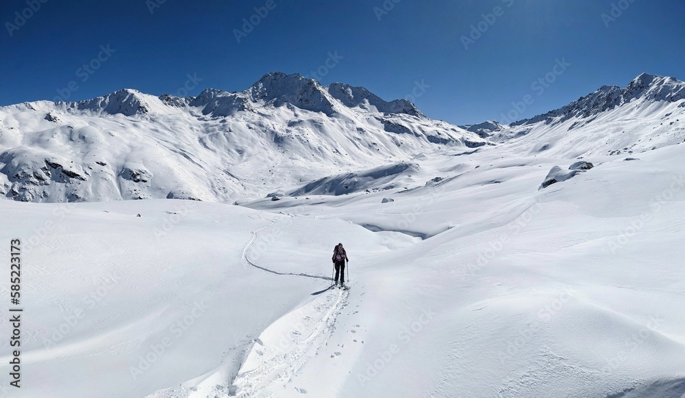 Skitour on the big mountains above davos with a view of the Flüelapass hospiz. Flueela pass. Ski mountaineering in a breathtaking winter landscape. High quality photo