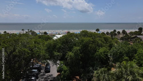 2022 - Excellent aerial footage raising over the palm trees to show the beach at Hilton Head, South Carolina. photo