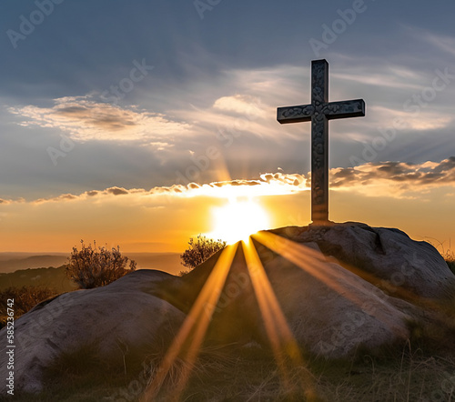 Religious cross on hill at sunset photo