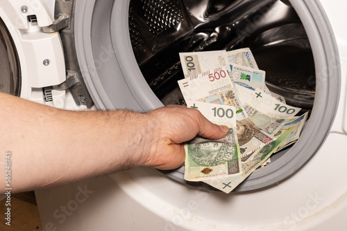 Polish money thrown into the washing machine, Concept, Money laundering, Illegal activity proceeds, Dark business, Black market, Bundle of top series banknotes, criminal activity