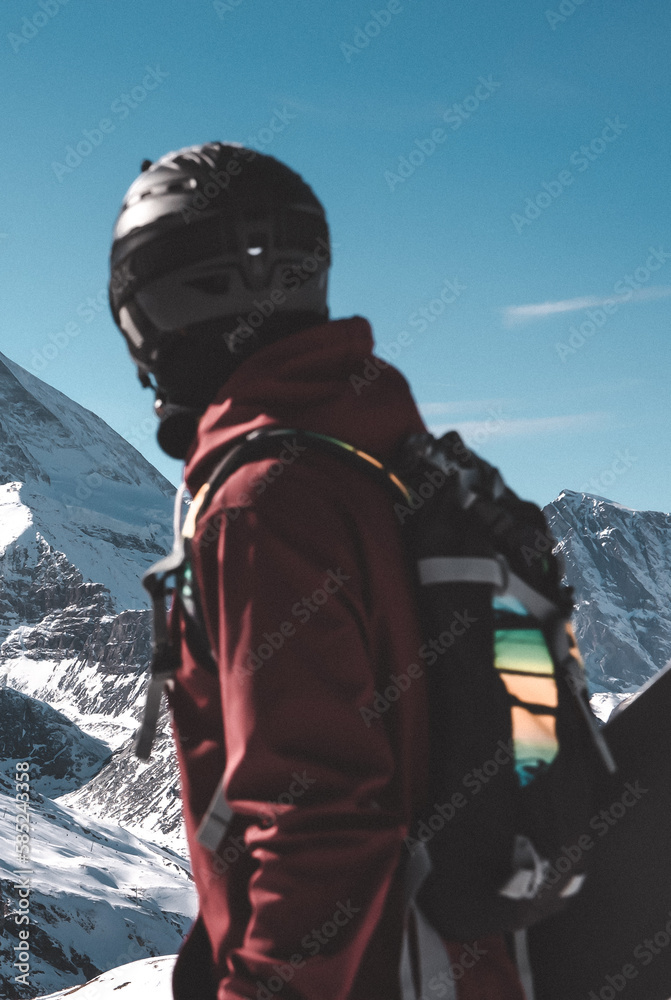 Young snowboarder spending winter holidays in Zermatt, near the famous Matterhorn peak. Male posing in Swiss Alps for the snowboarding season.