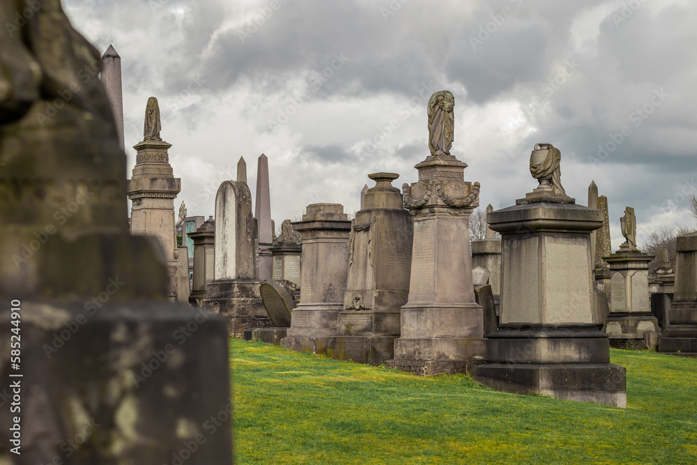 Glasgow necropolis on a cloudy and sunny day, large picturesque graveyard on a hill above Glasgow with many magnificent tombstones