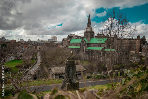 Big Glasgow cathedral on a spring day looking from above at the location of Glasgow Necropolis. Cloudy day and a big victorian cathedral church