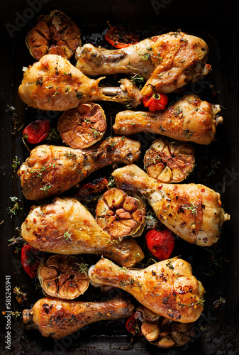Grilled spicy chicken legs, drumsticks with addition of habanero peppers, garlic and herbs on a grilled plate, top view