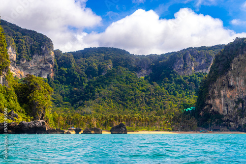 Tropical paradise turquoise water beach and limestone rocks Krabi Thailand. © arkadijschell