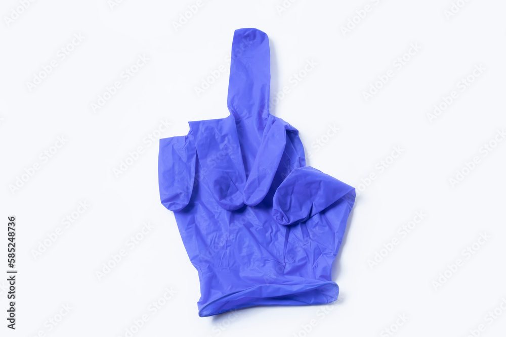 Blue surgical glove with flipped middle finger. Top view Blue surgical glove with flipped middle finger. Top view