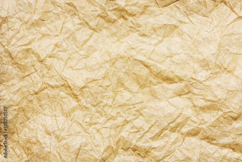 Yellow stained paper. Old retro letter texture. Parchment paper background. Secret letter backdrop. Crumpled paper. Wrinkled page. 