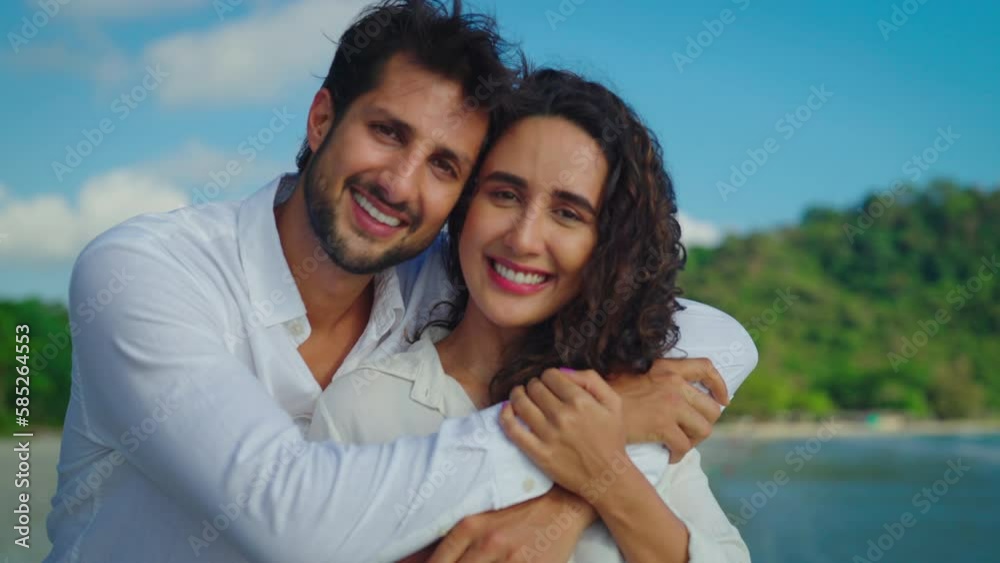 Young Latin couple looks towards the camera with beaming smiles, their affection for each other radiating from their eyes and warming the hearts of all who see them. Slow motion shot. Young Latin couple looks towards the camera with beaming smiles, their affection for each other radiating from their eyes and warming the hearts of all who see them. Slow motion shot.