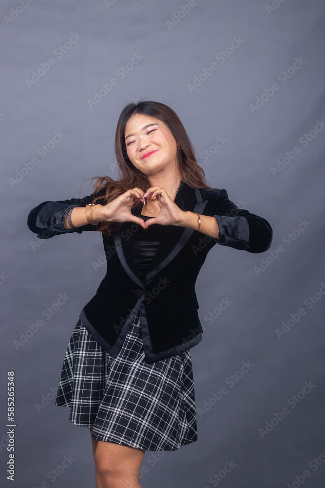 beautiful chinese asian women dressed in formal office wear jackets and skirts. the girl's expression smiles cheerfully in a formal pose, her hands all show a strong slanted body beautiful chinese asian women dressed in formal office wear jackets and skirts. the girl's expression smiles cheerfully in a formal pose, her hands all show a strong slanted body