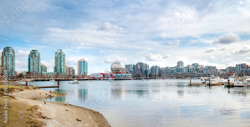 Touristic waterfront city panorama on a sunny spring day with modern highrise buildings, anchored boats and Science World. False Creek, Vancouver, BC, Canada. Selective focus. photo