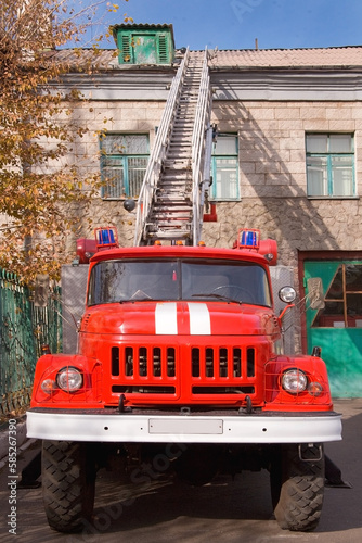 A large soviet red fire truck ZIL is preparing to leave.