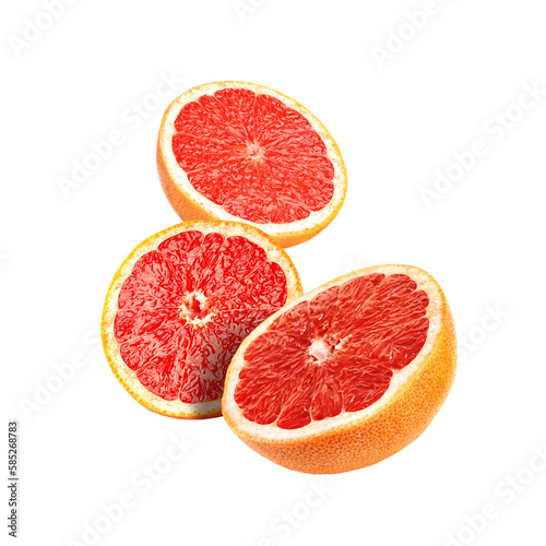 Cut fresh grapefruits flying on white background