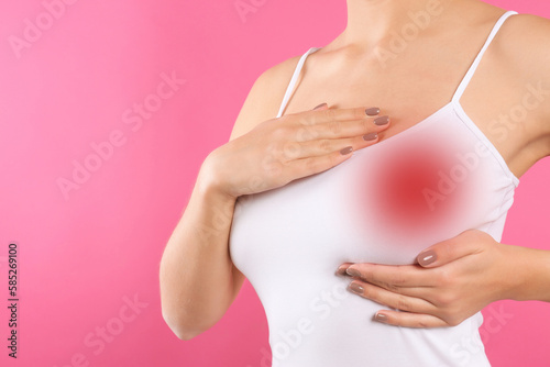 Wallpaper Mural Woman checking her breast on pink background, closeup Torontodigital.ca