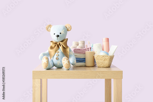 Toy bear with baby clothes ...