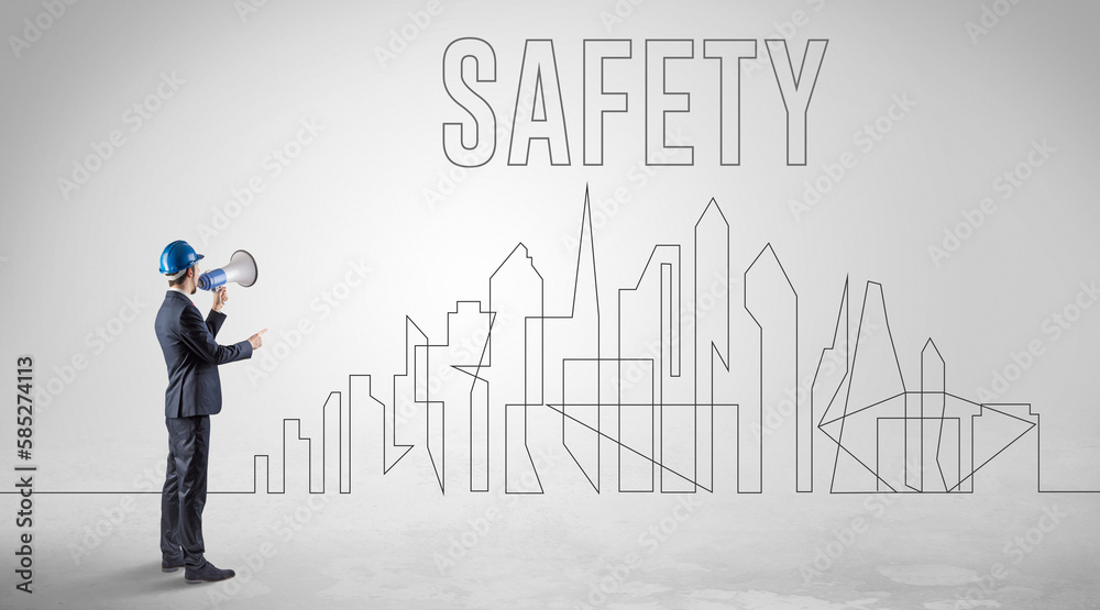 Businessman in hard hat holding blueprint Businessman in hard hat holding blueprint