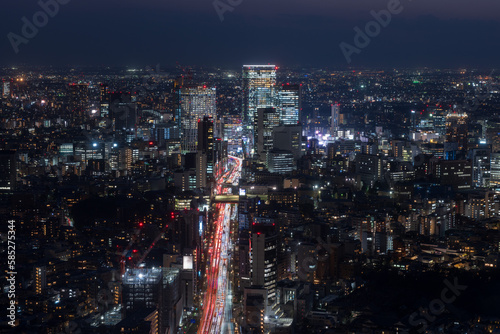 Tokyo Shibuya area panoramic view with car light trails at night.