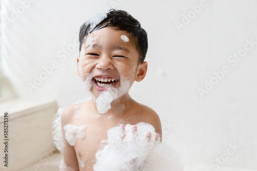 boy taking a bath in the tub take bath he plays with bubbles