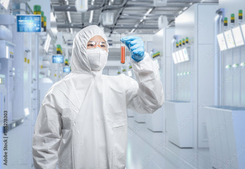 Worker wears medical protective suit or coverall suit with test tube in laboratory Worker wears medical protective suit or coverall suit with test tube in laboratory
