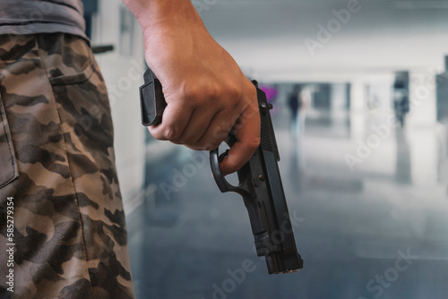 Konstfotografi an armed criminal with a dhrt pistol enters the premises