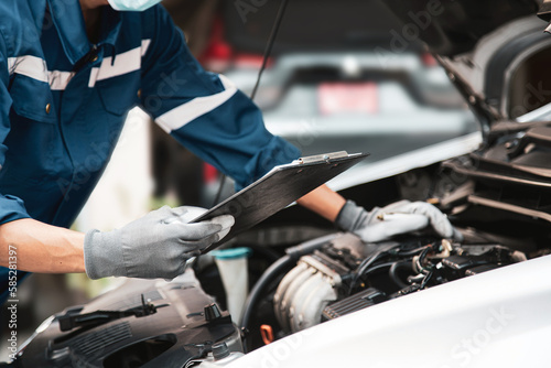 Car care maintenance and servicing, Hand technician auto mechanic using checklist after fix car or repairing change spare part engine problem and insurance service support the range of car check.