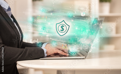 Young man watching stock market on laptop