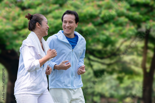 Happy Asian senior couple running exercising outdoors at park in morning © chomplearn_2001