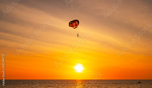 Silhouette Travel people Parasailing over sea Against sky during sunset in golden hour of sunset or sunrise sky,Active and extreme recreation