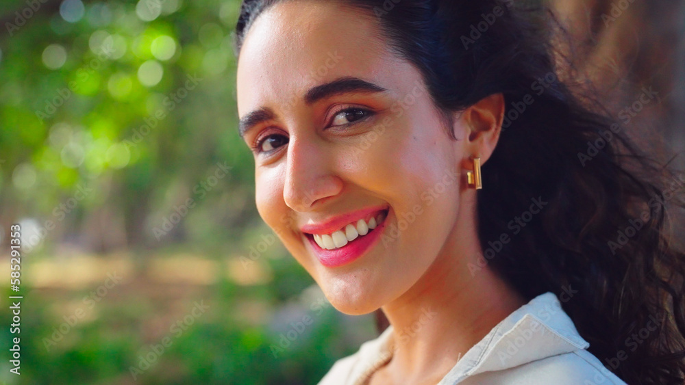 Beautiful young woman with happy expression at tree background. Lifestyle, Travel, Happiness, Nature, Wellbeing, Vacation, Summer, Expression, Enjoyment and Environment concept.