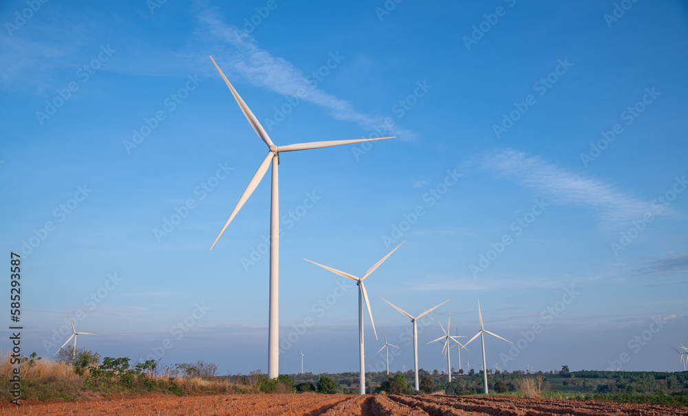 Field of electric windmill ecological alternative technology from environment to energy power plant with blue sky background.