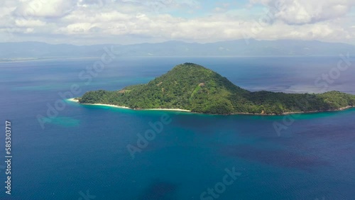 Tropical island and blue sea, aerial view. Atulayan Island, Camarines Sur, Philippines. Seascape with a green island. Summer and travel vacation concept. photo