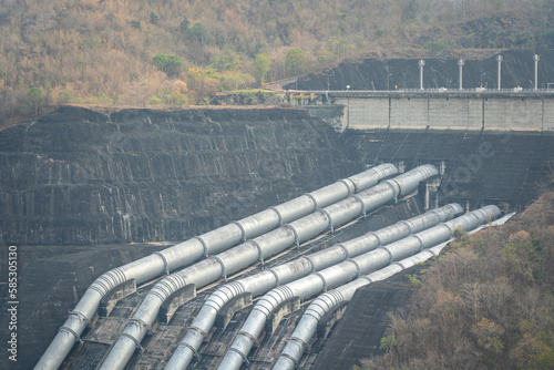 Huge metal pipeline structure on the electricity hydropower plant. Industrial and transportation equipment system object.  photo