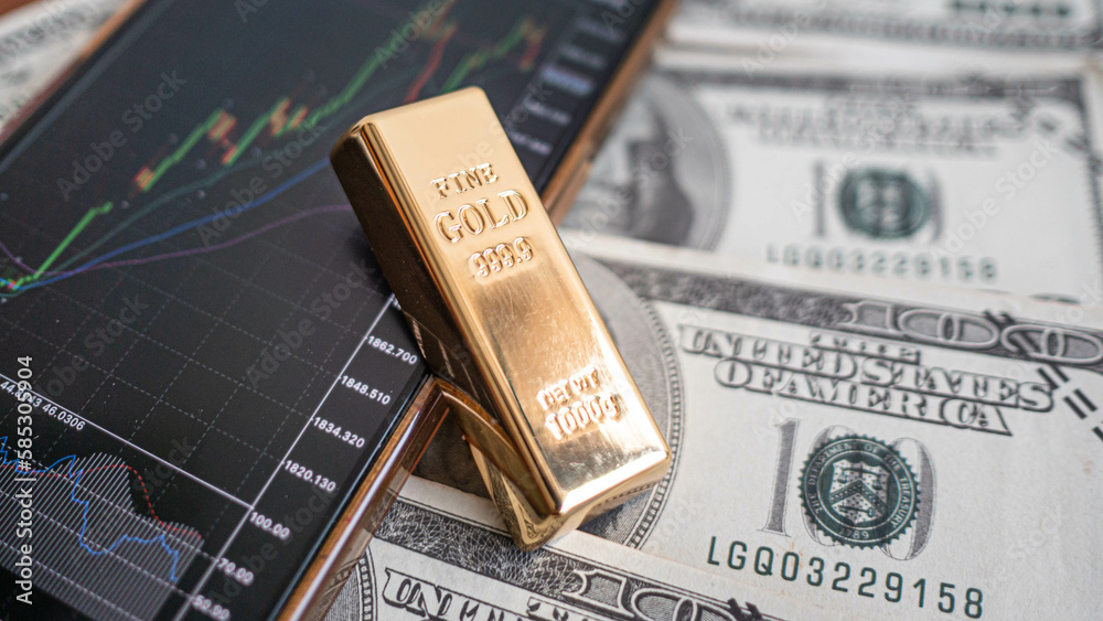 gold bars place on the phone that opens the candlestick chart. and dollar. Fluctuations in gold prices concept. gold bars place on the phone that opens the candlestick chart. and dollar. Fluctuations in gold prices concept.