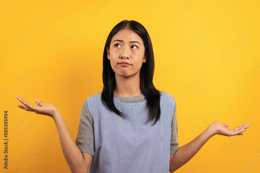 Young asian woman in casual clothes raising to open hands and co Young asian woman in casual clothes raising to open hands and co