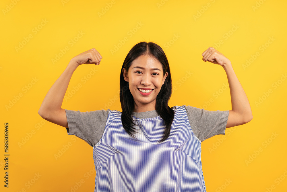 Young asian woman in casual clothes feeling strong from exercisi