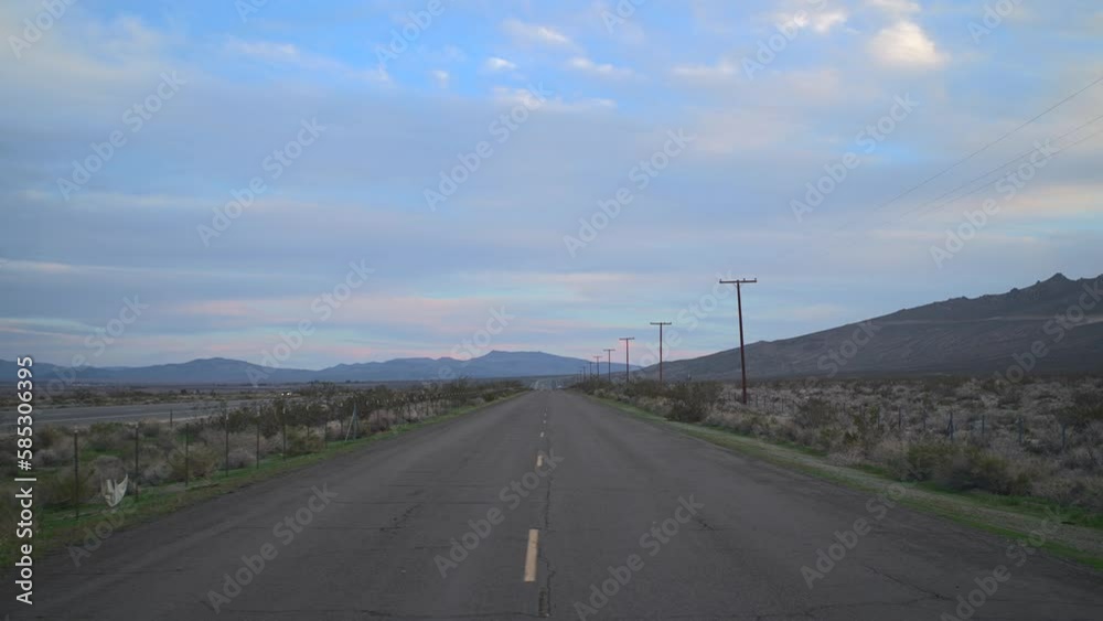 A solitary road traversing an unforgiving desert expanse A solitary road traversing an unforgiving desert expanse