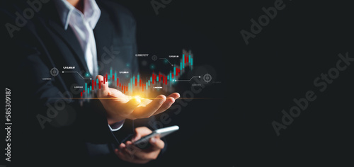 Businessman trader or stock market investor showing business growth chart Investing in online finance on virtual hologram,Plan analyzing goal,Strategy for investment, learning technology,Updated news.