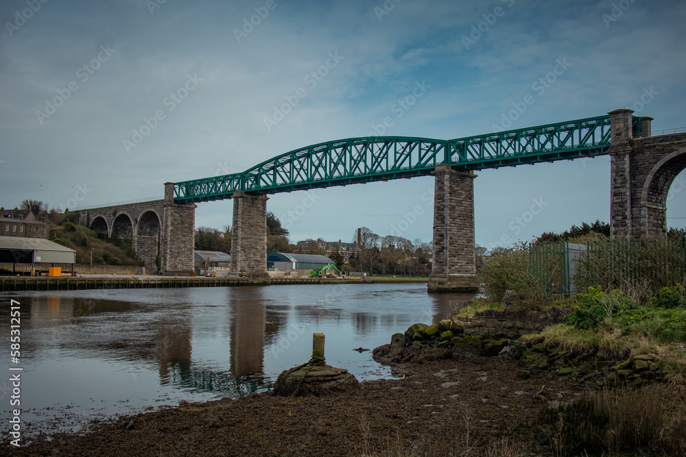 Panorama of Boyne viaduct in drogheda spanning over river Boyne in early evening hours. Beautiful pucture of a green metal viaduct and stone arches.