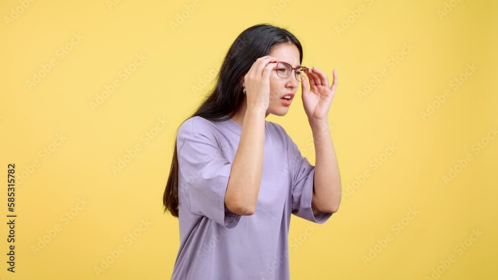 Woman taking off her glasses to see far away Woman taking off her glasses to see far away