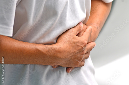 Man having abdominal pain ,stomach ech causes of gastritis, stomach ulcer, food poisoning, diarrhea.