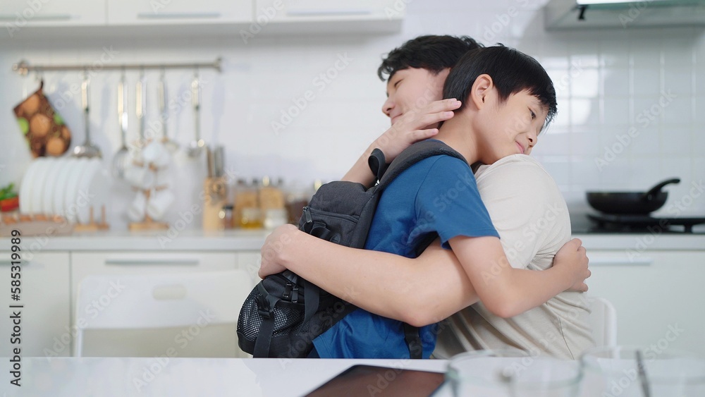 Asian single father and son hugging each other before going to school. Happy family concept. Single father concept Asian single father and son hugging each other before going to school. Happy family concept. Single father concept